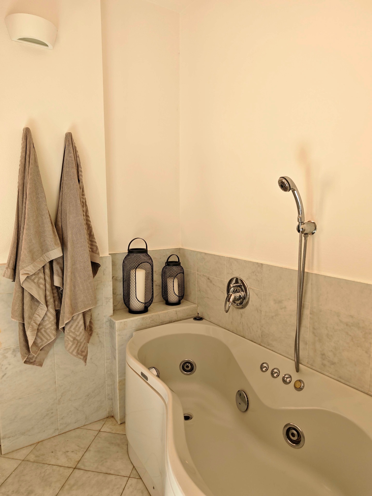 Bathroom corner whirlpool tub with chrome shower and soft neutral finishes