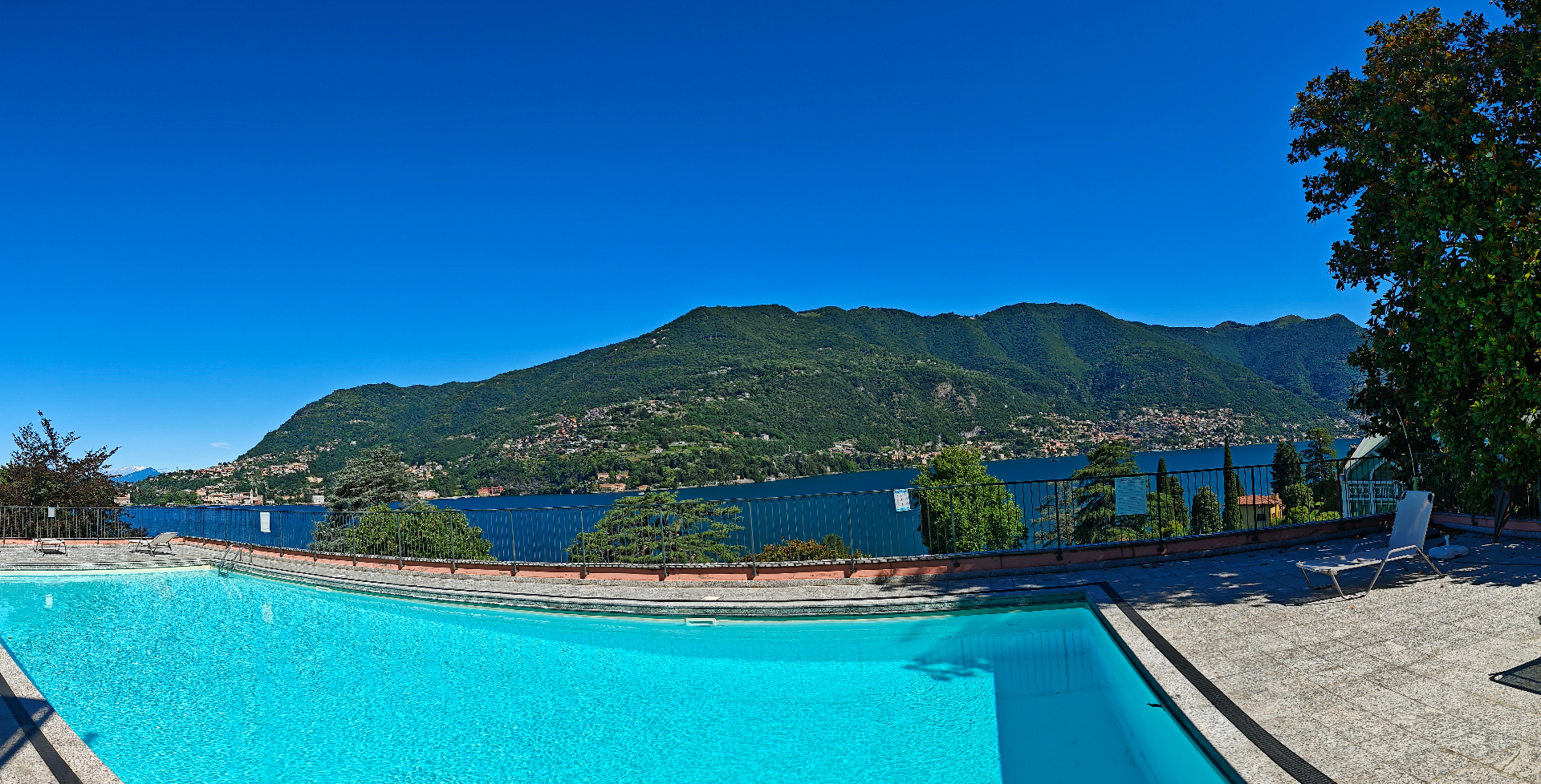 Panoramic view of the shared pool with Lake Como and the mountains behind
